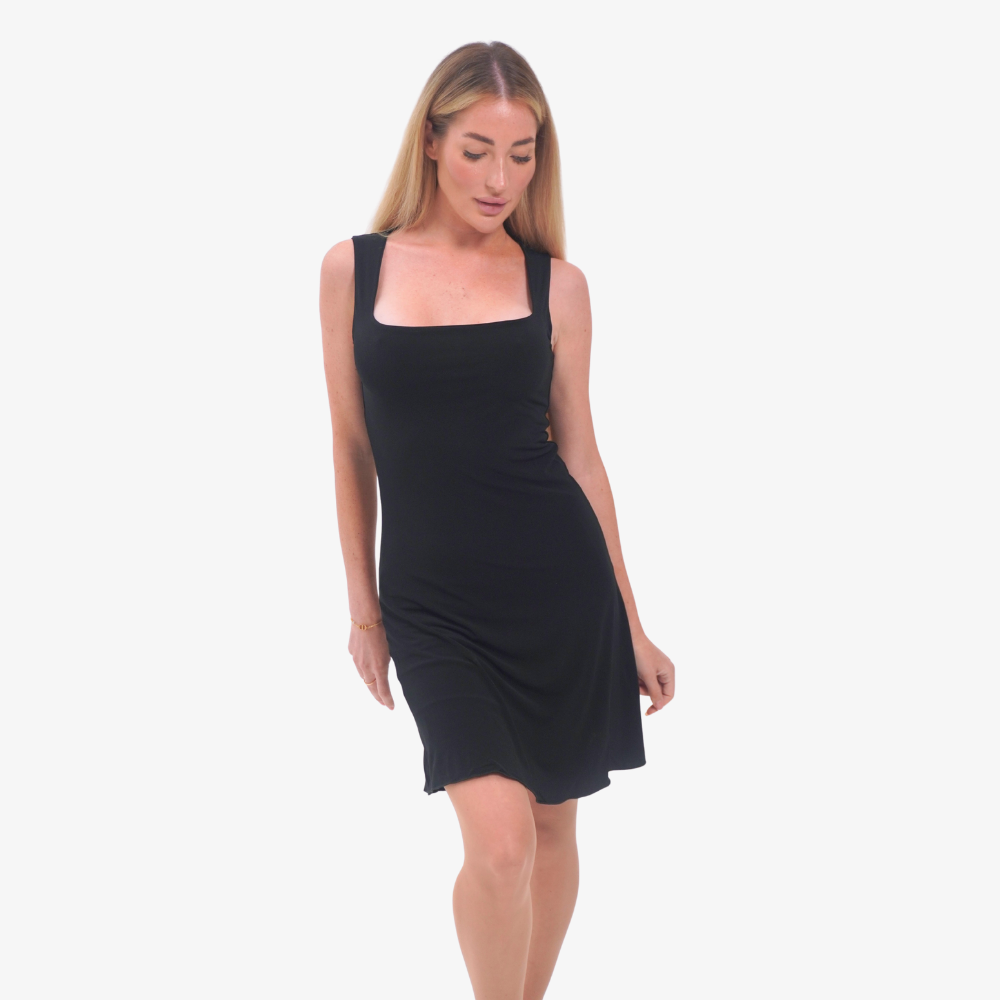 Carmen mini dress Woman wearing a black sleeveless dress on a white background