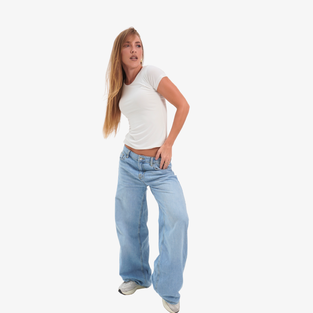 Olivia t-shirt Woman wearing a white t-shirt and light blue jeans on a white background