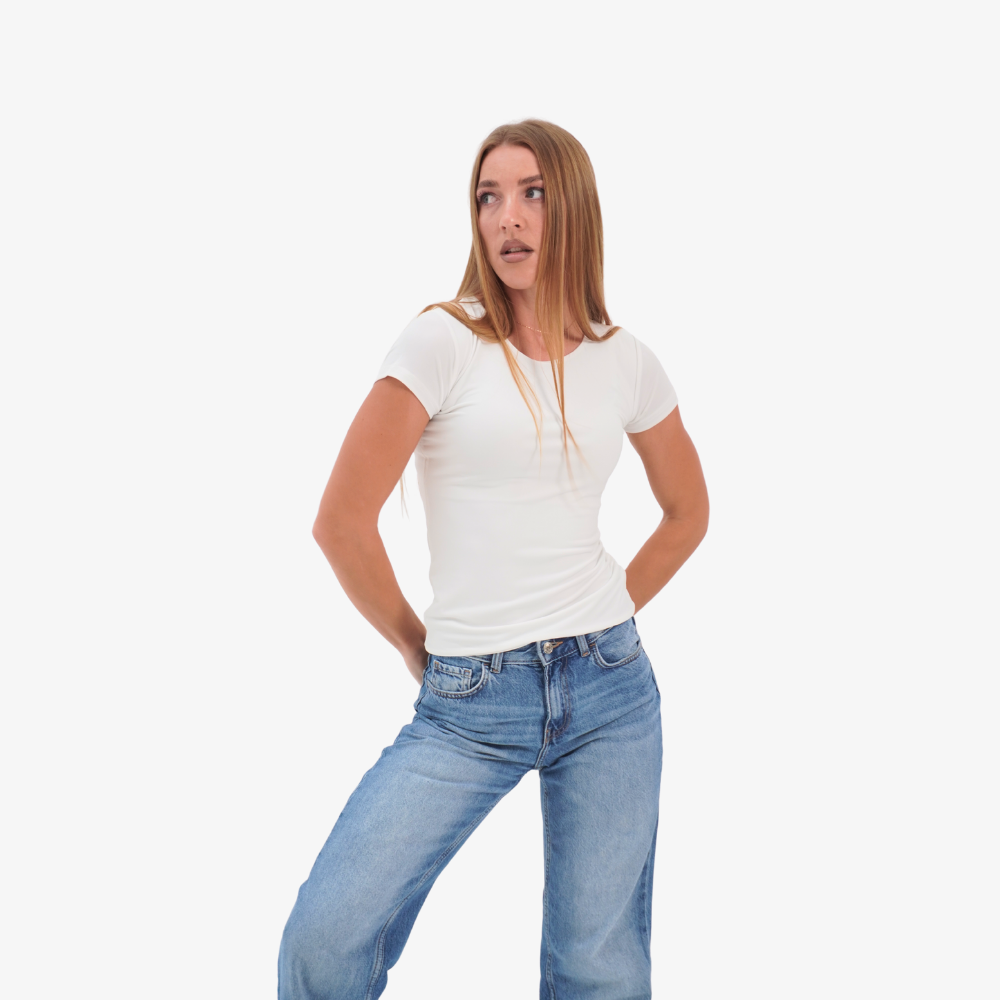 Olivia t-shirt Woman wearing a white t-shirt and blue jeans on a white background