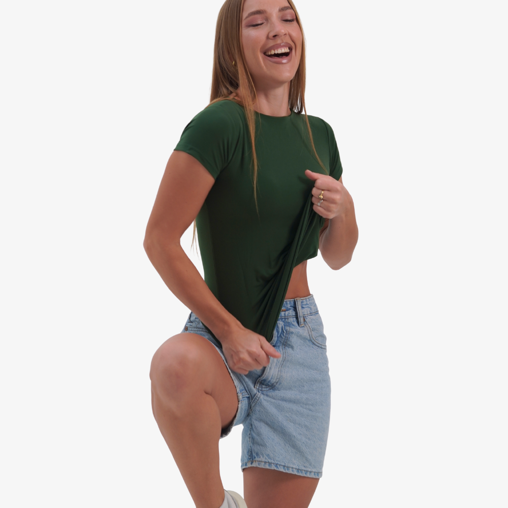 Olivia t-shirt Woman wearing a green t-shirt and denim shorts on a white background