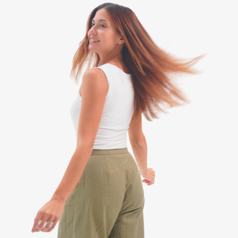 Charlotte top Woman with long hair blowing in the wind against a white background