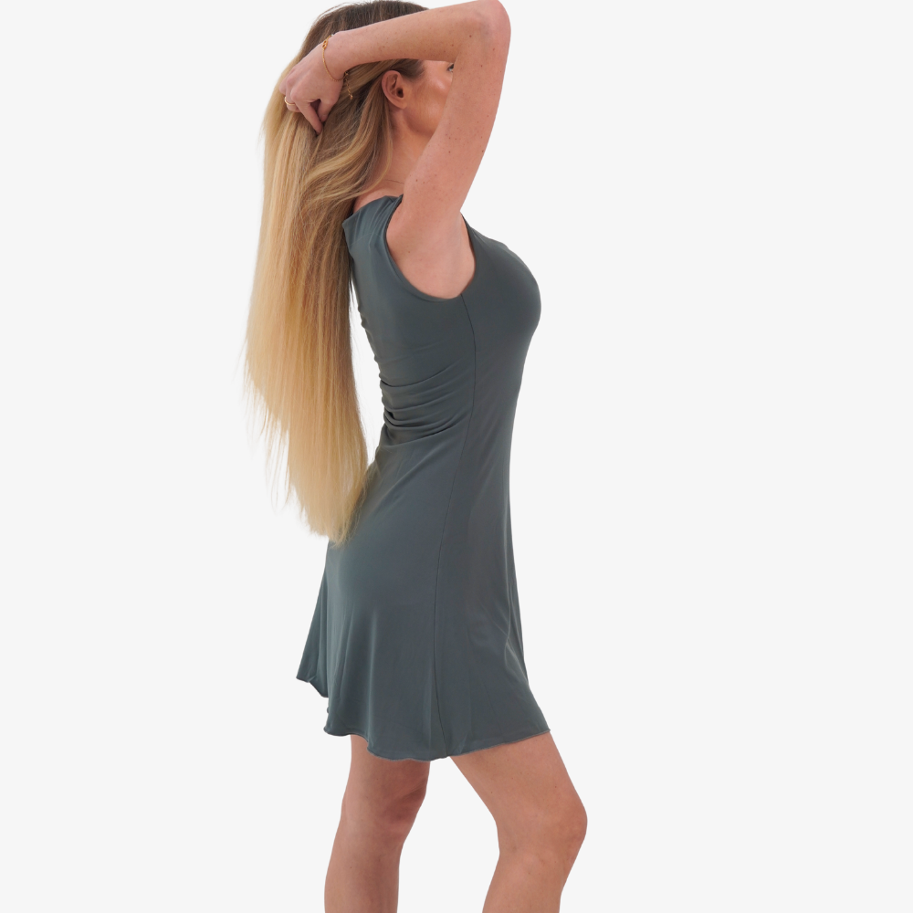 Carmen mini dress Woman wearing a sleeveless green dress on a white background