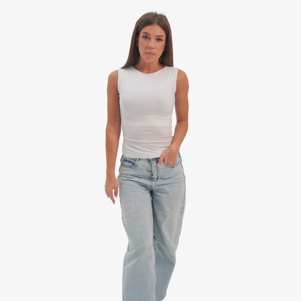 Emma - straight neckline top Woman wearing a white sleeveless top and light blue jeans on a white background
