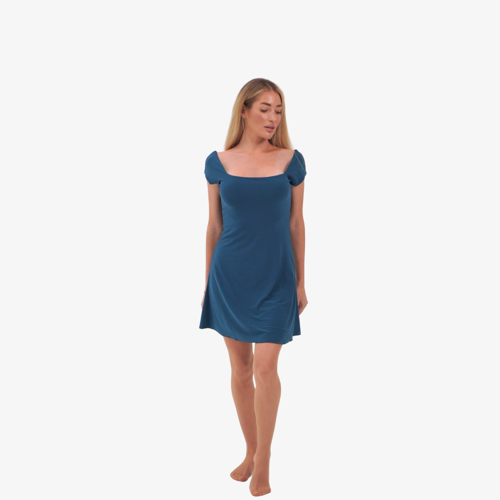 Tcheriz' Gigi mini dress Woman wearing a petrol blue dress on a white background