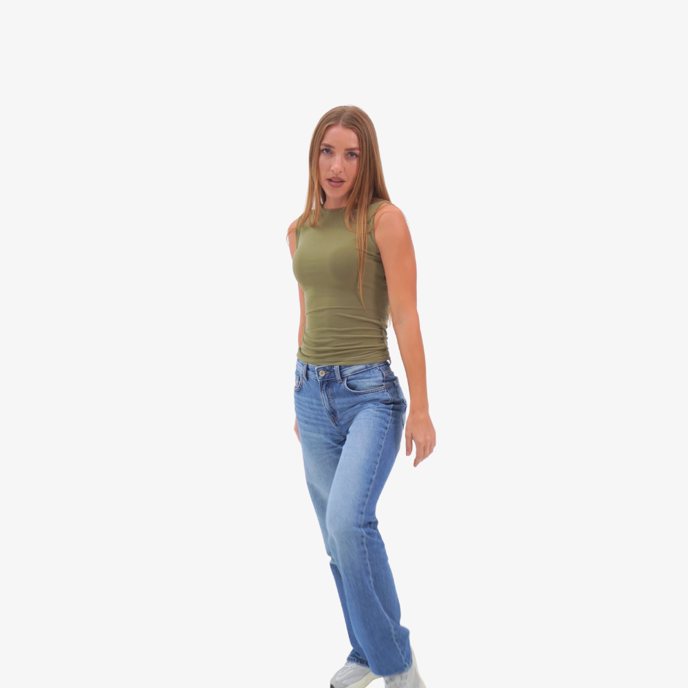 Emma - straight neckline top Woman wearing a green sleeveless top and blue jeans on a white background