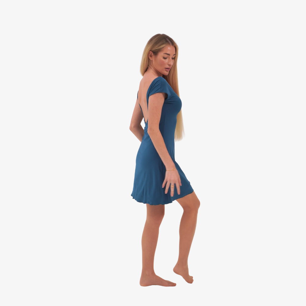 tcheriz gigi mini dress. Woman wearing a blue dress on a white background